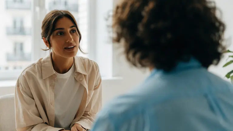 A woman talking with a clinician during a consultation.