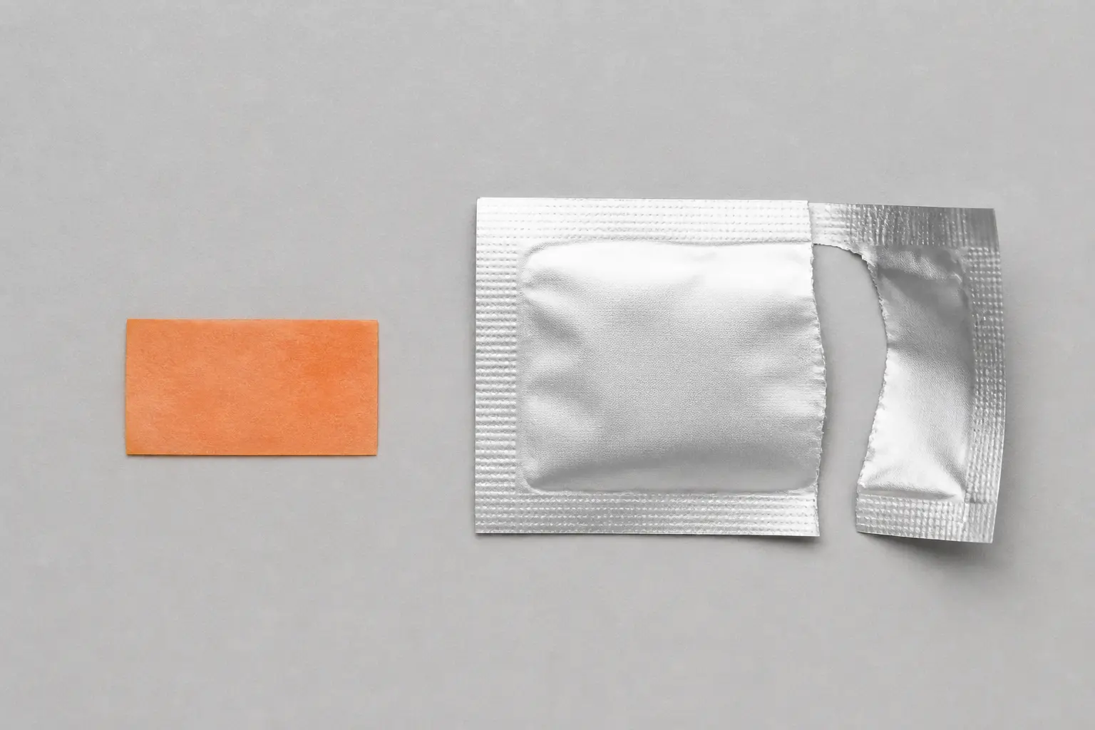 An orange sublingual film beside its opened foil sachet, showing the dosage form used in buprenorphine treatment.