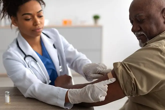 doctor placing a bandage on a patient after administering a Vivitrol injection