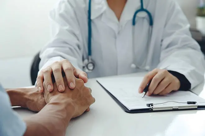 doctor holding a patient's hand as they continue their Suboxone or Vivitrol treatment at Brightside