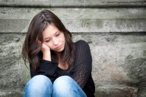 Teenage girl looking thoughtful about troubles